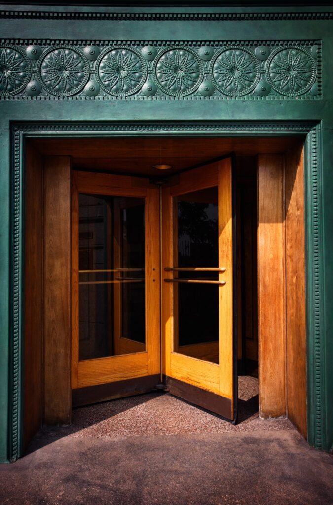 An ornate revolving door set within a decorative entryway, exemplifying the timeless design of revolving doors.